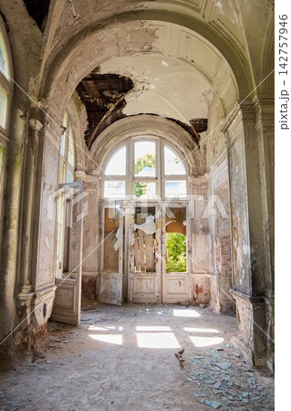 Historic grand hall with damaged frescoes and shattered glass Historic grand hall with damaged frescoes and shattered glass 142757946