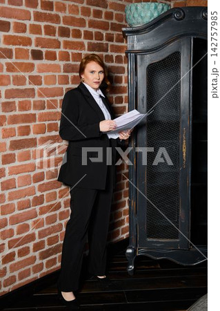 Caucasian entrepreneur rehearsing pitch with documents 142757985