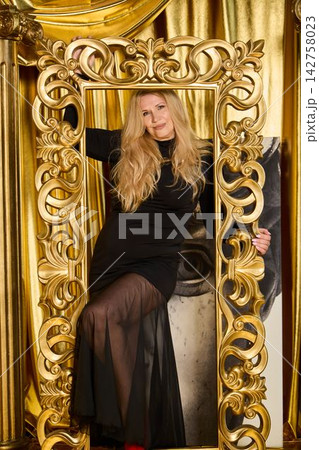 Dramatic scene featuring poised woman in glamorous attire Dramatic scene featuring poised woman in glamorous attire 142758023