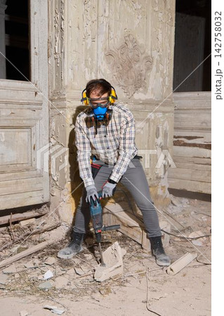 Operator uses safety equipment amid detailed removal process 142758032