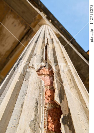 Closeup of weathered structure showing peeling plaster and exposed bricks Closeup of weathered structure showing peeling plaster and exposed bricks 142758072