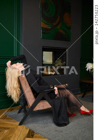 Sophisticated Caucasian woman in floral decor and chic attire Sophisticated Caucasian woman in floral decor and chic attire 142758223