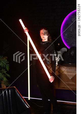 Cinematic visual featuring female figure with vibrant neon lighting effects Cinematic visual featuring female figure with vibrant neon lighting effects 142758224