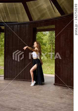 Elegant ballet student caucasian stretching in doorway 142758249