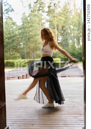 Young ballet artist performing casual spin in natural environment Young ballet artist performing casual spin in natural environment 142758309