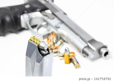 bullet 9mm  parabellum LRN ( lead round nose ) semi-wadcutter (SWC)  in magazines and 9mm postal gun in background. 142758792