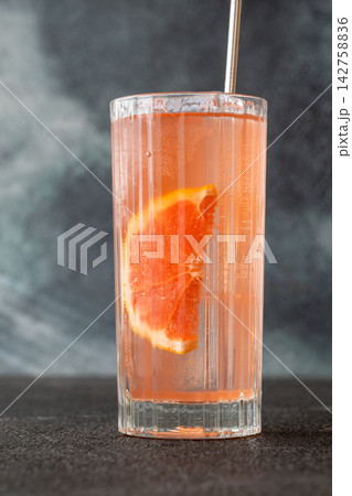 Refreshing pink Paloma cocktail with grapefruit ice bubbles and modern metal straw Refreshing pink Paloma cocktail with grapefruit ice bubbles and modern metal straw 142758836