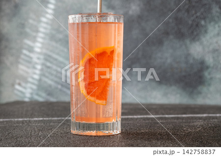 Refreshing pink Paloma cocktail with grapefruit ice bubbles and modern metal straw Refreshing pink Paloma cocktail with grapefruit ice bubbles and modern metal straw 142758837