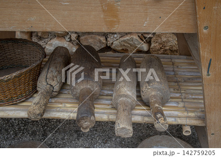 Traditional wooden mallets resting on a bamboo shelf for grape crushing in Spain Traditional wooden mallets resting on a bamboo shelf for grape crushing in Spain 142759205