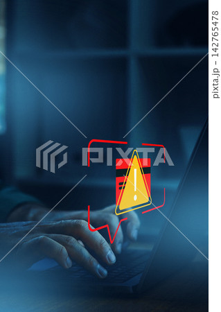 Alert on deepfake technology while a person types on a laptop in a home office setting at night Alert on deepfake technology while a person types on a laptop in a home office setting at night 142765478
