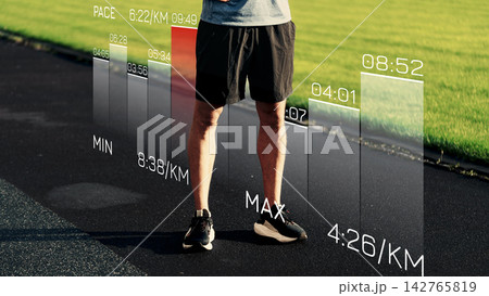 Sports performance data displayed on a track with a person standing nearby during a training session 142765819