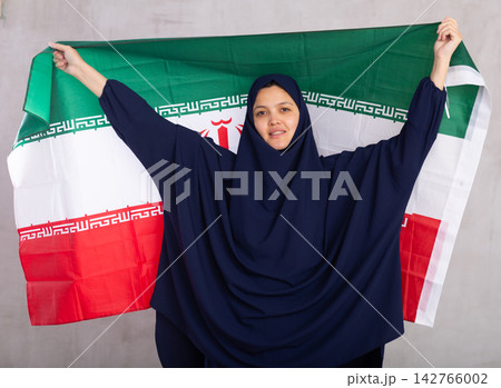 Young woman in hijab posing with Iran flag 142766002