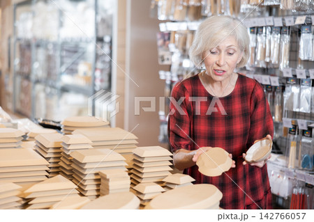 Buying wooden molds for clay products in pottery shop 142766057