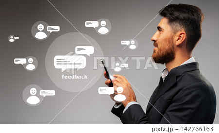 Man interacting with feedback icons on a mobile device in a professional setting 142766163