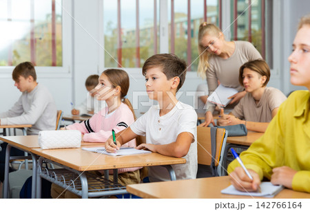 Schoolboy posing in classroom during lesson 142766164