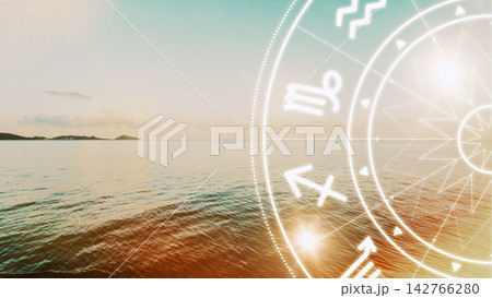 Zodiac signs overlay on a calm sea at sunset near a distant shoreline with soft waves Zodiac signs overlay on a calm sea at sunset near a distant shoreline with soft waves 142766280