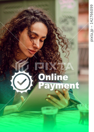 Woman uses tablet to make online payment while sitting in a cafe Woman uses tablet to make online payment while sitting in a cafe 142766899