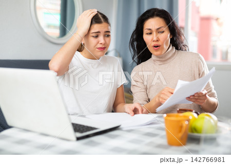 Worried LGBT couple working with papers Worried LGBT couple working with papers 142766981