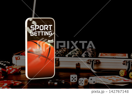Sport betting with basketball theme on mobile device and gaming items on table Sport betting with basketball theme on mobile device and gaming items on table 142767148