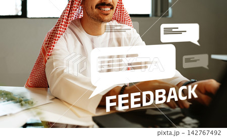 Man providing feedback in an office setting with chat bubbles displayed nearby 142767492