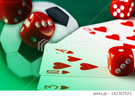 Sport bet with cards and dice on a green surface Sport bet with cards and dice on a green surface 142767523