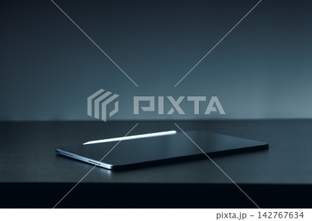 Laptop on a table in a dimly lit room during evening hours 142767634