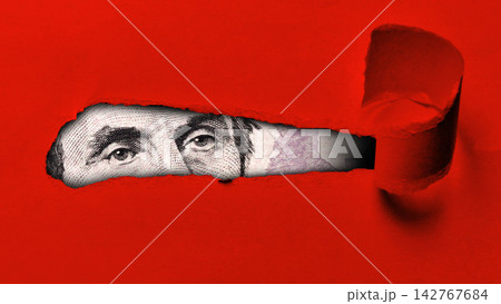 Close-up view of a dollar bill visible through a tear in red paper Close-up view of a dollar bill visible through a tear in red paper 142767684