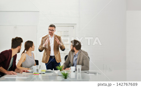 Meeting, research and business people in office for discussion on creative project together. Teamwork, planning and group of professional designers working in collaboration in workplace boardroom. 142767689