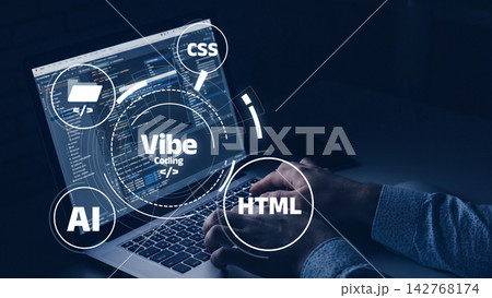 Vibe coding is shown on a laptop screen at night with coding elements highlighted around the device 142768174