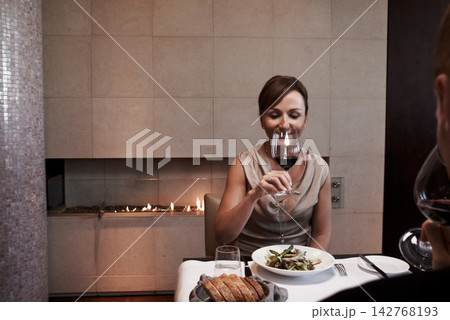 Drink, wine and woman on date at restaurant with food on table at fine dining dinner, Person, relax and enjoy glass of luxury alcohol on holiday, vacation or smile at night with partner at winery 142768193
