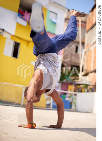 Capoeira, dance and man on street in Brazil for exercise, skill and entertainment in city. Martial arts, breakdancing and male performer in Rio de Janeiro for acrobatics, spirituality or self defense 142768806