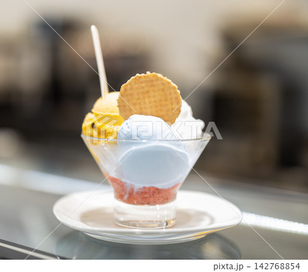 Three scoops of ice cream in a glass container close up Three scoops of ice cream in a glass container close up 142768854