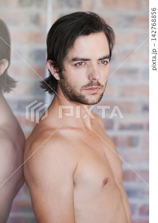 Model, guy and shirtless in home with thinking, skincare and confidence on brick wall in apartment. Man, model and cosmetic with topless person in house with pride and calm energy in morning 142768856
