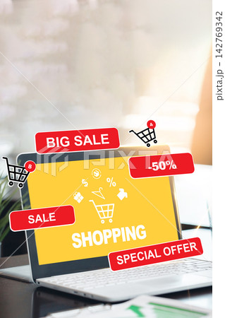 Online shopping with sale signs on a laptop at a desk during daytime 142769342