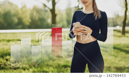 Sport activity and data tracking in a park during daytime with a person using a smartphone 142769453