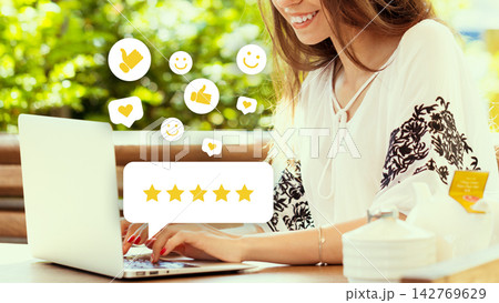 Woman using laptop outdoors while interacting with social media and reviewing content Woman using laptop outdoors while interacting with social media and reviewing content 142769629