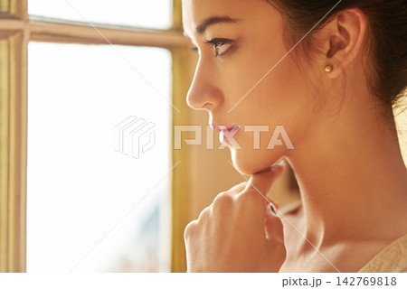 Woman, beauty and luxury in closeup for fancy, elegant and classy in thinking by window for wealth aesthetic. Female person, style and vintage mansion at gala, party or event with confidence or pride Woman, beauty and luxury in closeup for fancy, elegant and classy in thinking by window for wealth aesthetic. Female person, style and vintage mansion at gala, party or event with confidence or pride 142769818