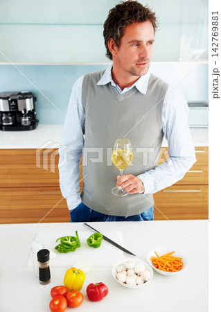 Drinking wine, man and cooking vegetables in home for healthy diet, vegan food or thinking of nutrition. Alcohol glass, dream and person in kitchen for lunch meal prep, dinner or organic salad idea Drinking wine, man and cooking vegetables in home for healthy diet, vegan food or thinking of nutrition. Alcohol glass, dream and person in kitchen for lunch meal prep, dinner or organic salad idea 142769881