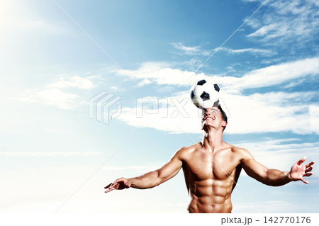 Soccer ball, blue sky and man for practice, head and fitness for action and football athlete. Summer, blue sky and sports for male person and fit body for wellness and heath, training and game field 142770176