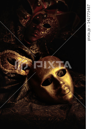 Golden carnival masks on a dark background. Golden carnival masks on a dark background. 142773487