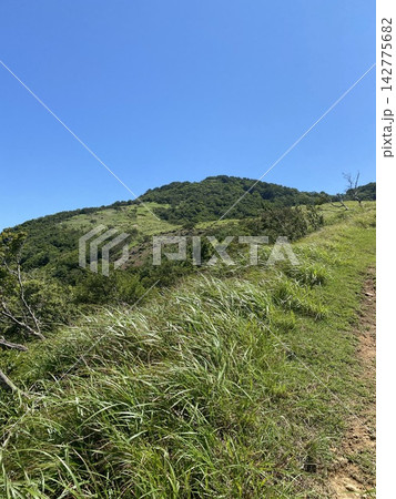 広い青空と緑の山を望む夏のトレッキングコース 142775682