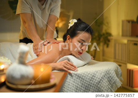 Photo set of Woman receiving shoulder massage at spa with warm light and deep relaxation mood Photo set of Woman receiving shoulder massage at spa with warm light and deep relaxation mood 142775857
