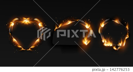Dark paper with burnt edges forming various shapes and glowing with fire sparks Dark paper with burnt edges forming various shapes and glowing with fire sparks 142776253