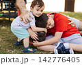 Family brothers bonding with cerebral palsy child 142776405