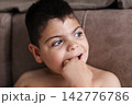 Child with intellectual disability looking away thoughtfully 142776786
