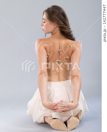 Sexy topless girl poses in studio. View from behind Sexy topless girl poses in studio. View from behind 142777447