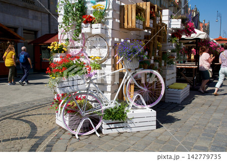 Wroclaw, Poland, June 16, 2018: Decorative white bicycle with colorful flowers at Market Square 142779735