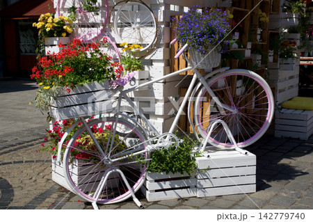 Wroclaw, Poland, June 16, 2018: Decorative white bicycle with colorful flowers at Market Square 142779740