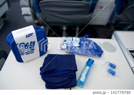 Warsaw, Poland, May 10 2018: Premium economy amenity kit contents displayed on tray table Warsaw, Poland, May 10 2018: Premium economy amenity kit contents displayed on tray table 142779780