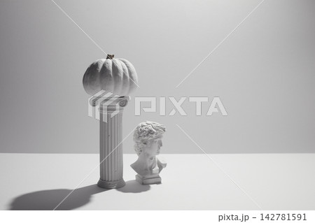 White pumpkin balancing on column with david bust White pumpkin balancing on column with david bust 142781591